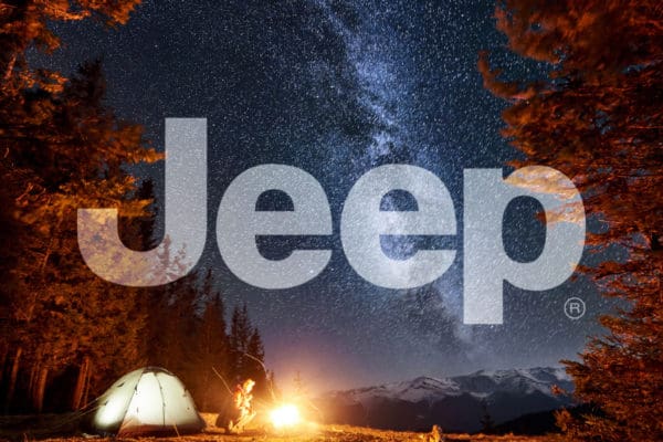 Jeep logo over scenic campout for automotive brand guidelines and licensing style guide.