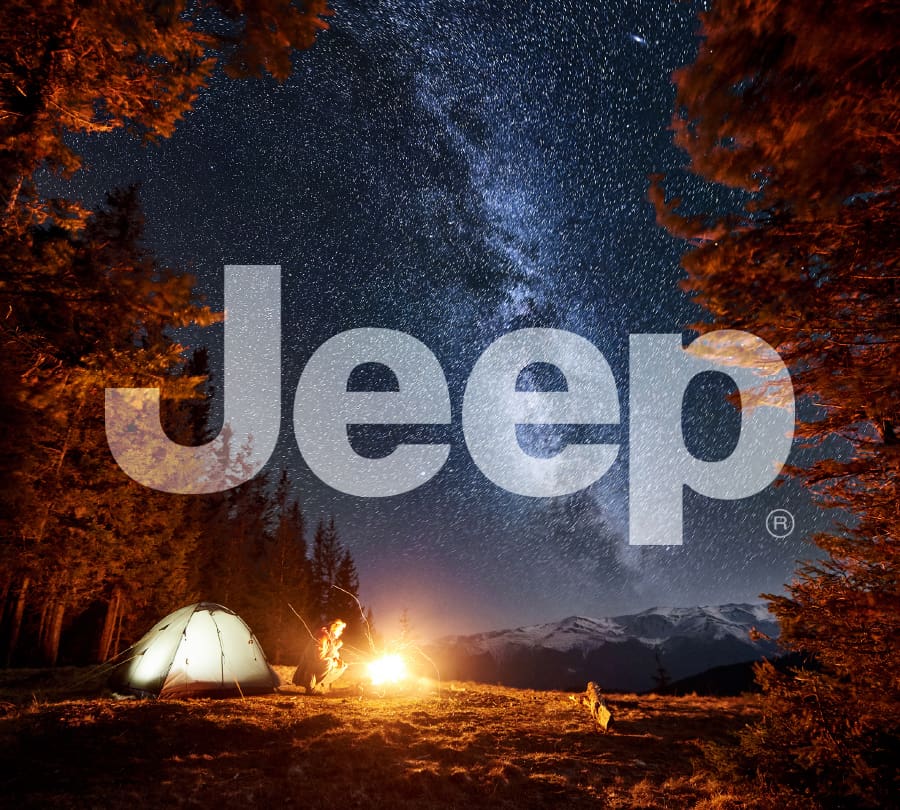 Jeep logo over scenic campout for automotive brand guidelines and licensing style guide.
