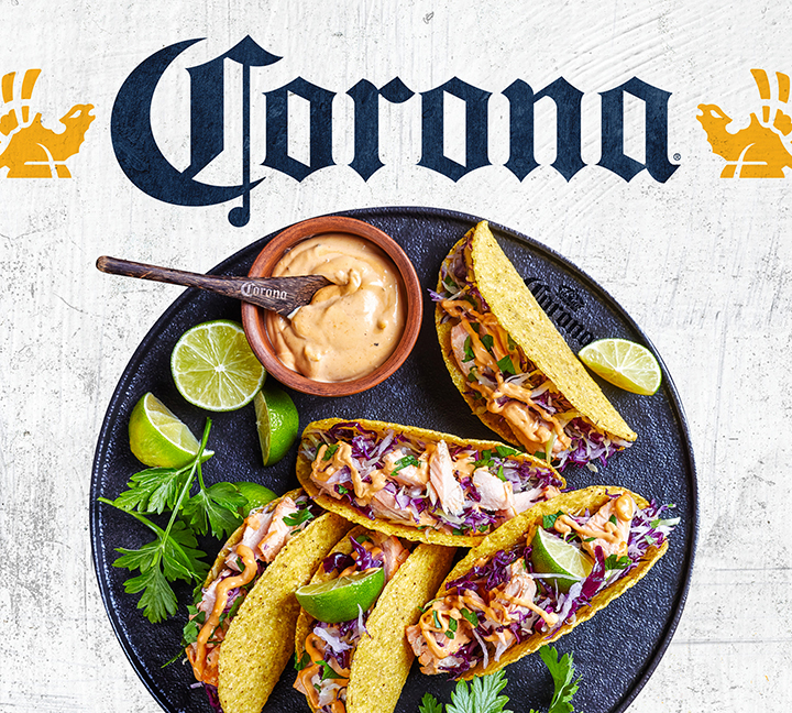 Portfolio: Corona logo and griffins above plated tacos for consumer packaged goods licensing style guide.